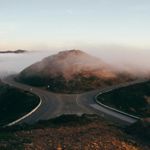 Two roads diverging in front of a mountain that might symbolize a writer accepting defeat and taking a different path to their chosen goal.